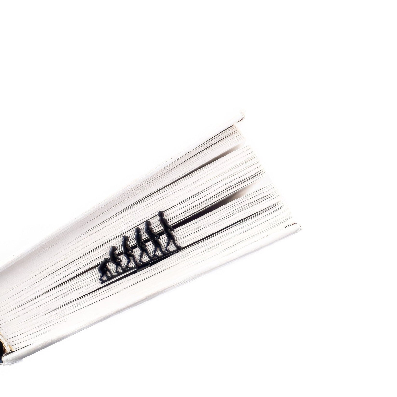Evolution metal bookmark marking a page in an open book