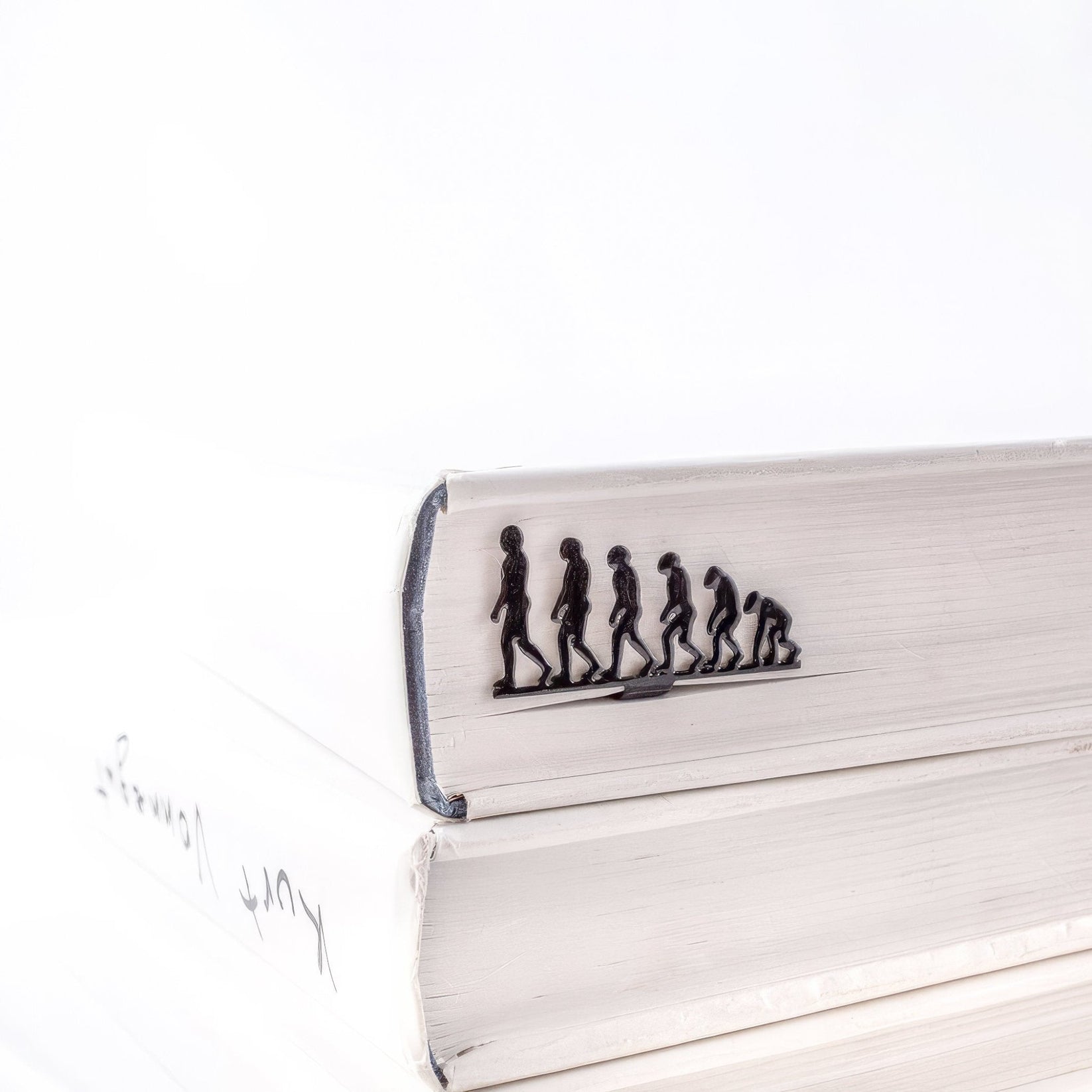 Evolution metal bookmark seen from the edge of a closed book