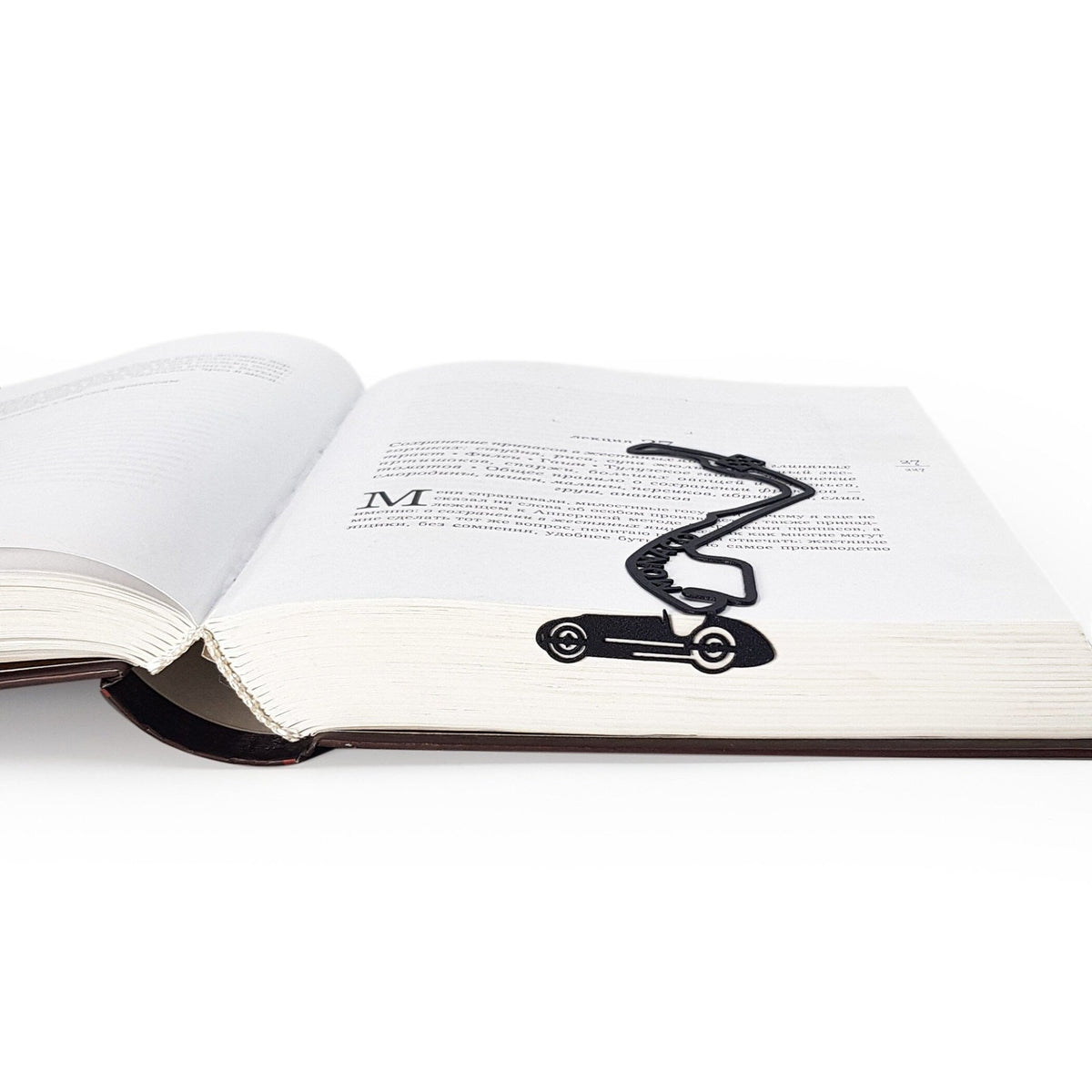 F1 Monaco Race Car metal bookmark lying across the pages of an open book