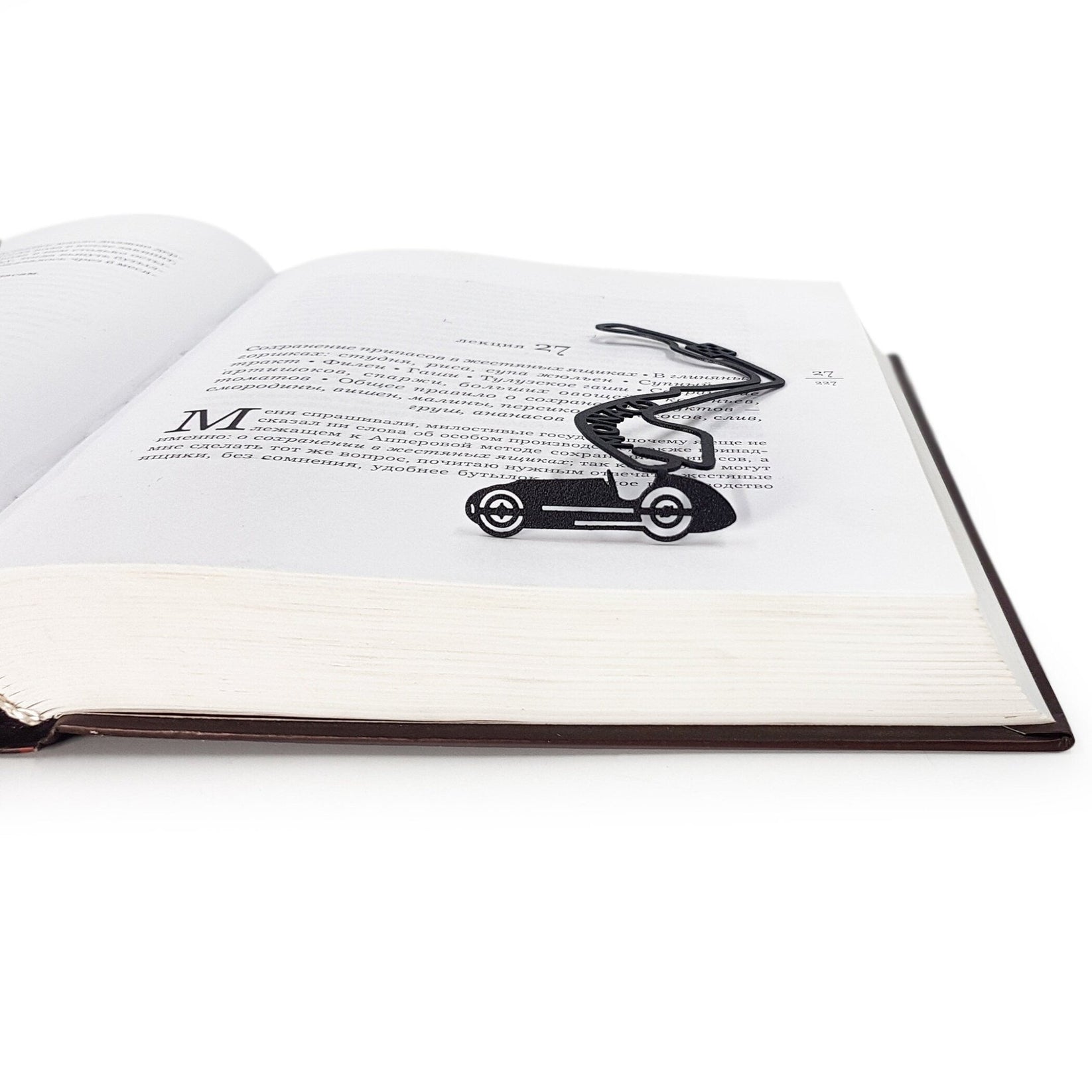 F1 Monaco Race Car metal bookmark resting on the pages of an open book