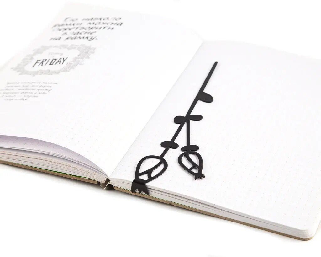 Field Flowers metal bookmark resting on the pages of an open book
