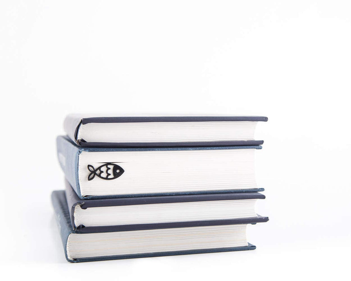 Fish metal bookmark shown with a stack of books