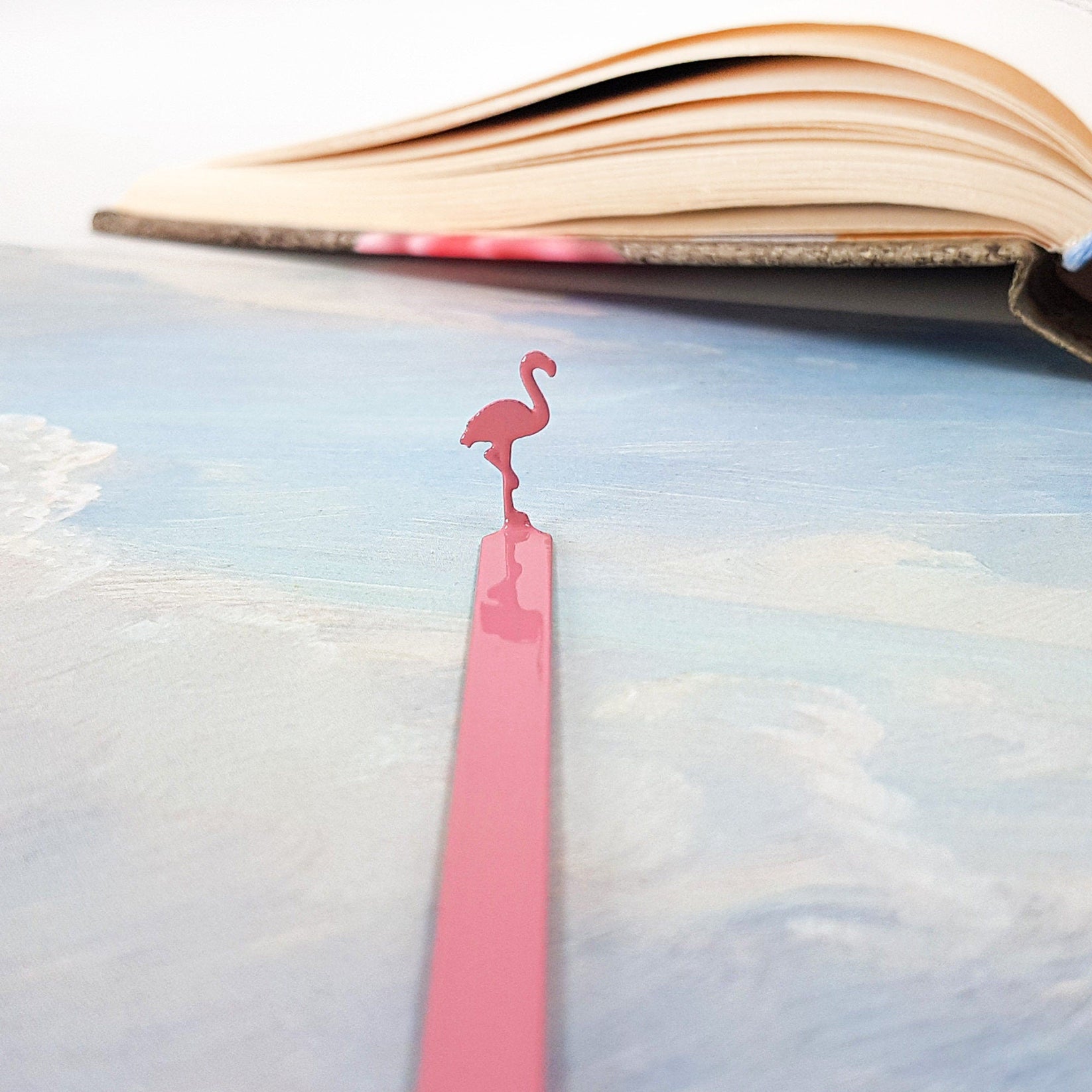 Flamingo metal bookmark in red on a coloured background