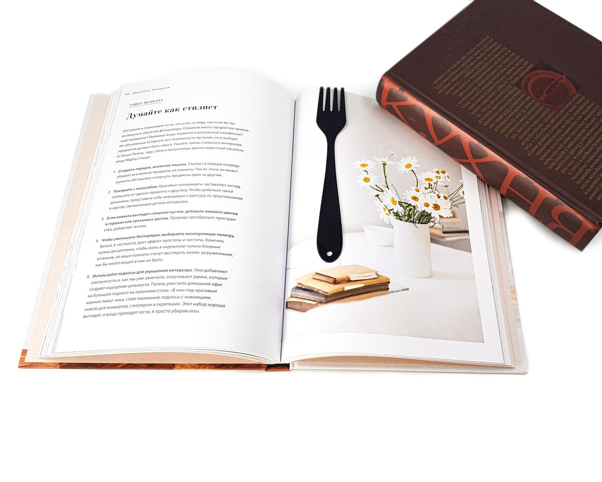 Fork metal bookmark resting on the pages of an open book