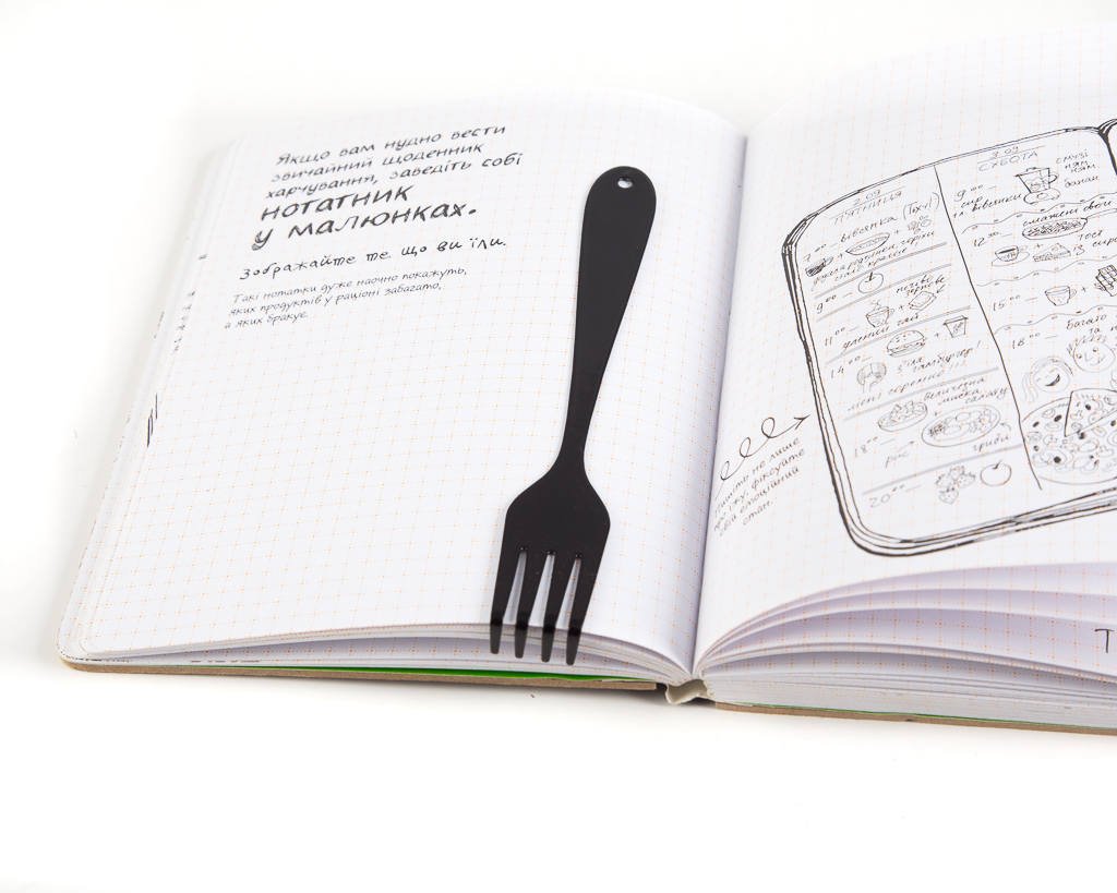 Fork metal bookmark on an illustrated page