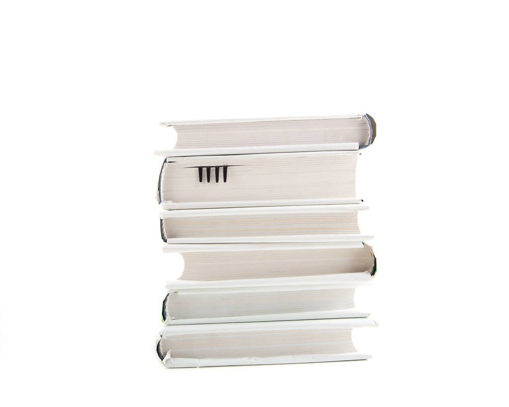 Fork metal bookmark shown with a stack of books