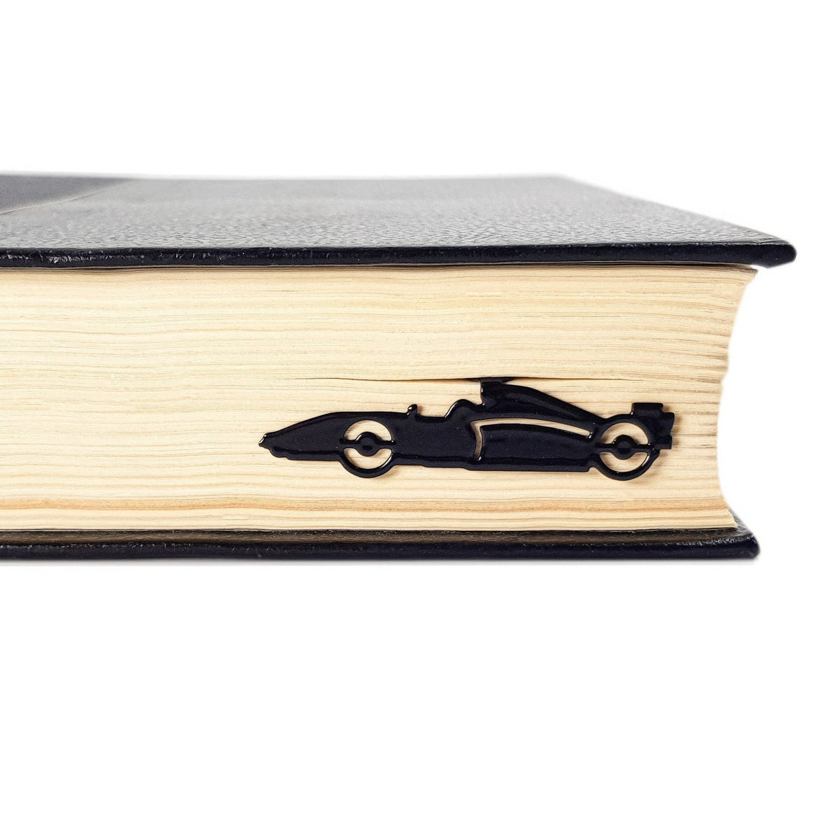 Formula One Indy Car metal bookmark in a closed book, only its top showing above the pages