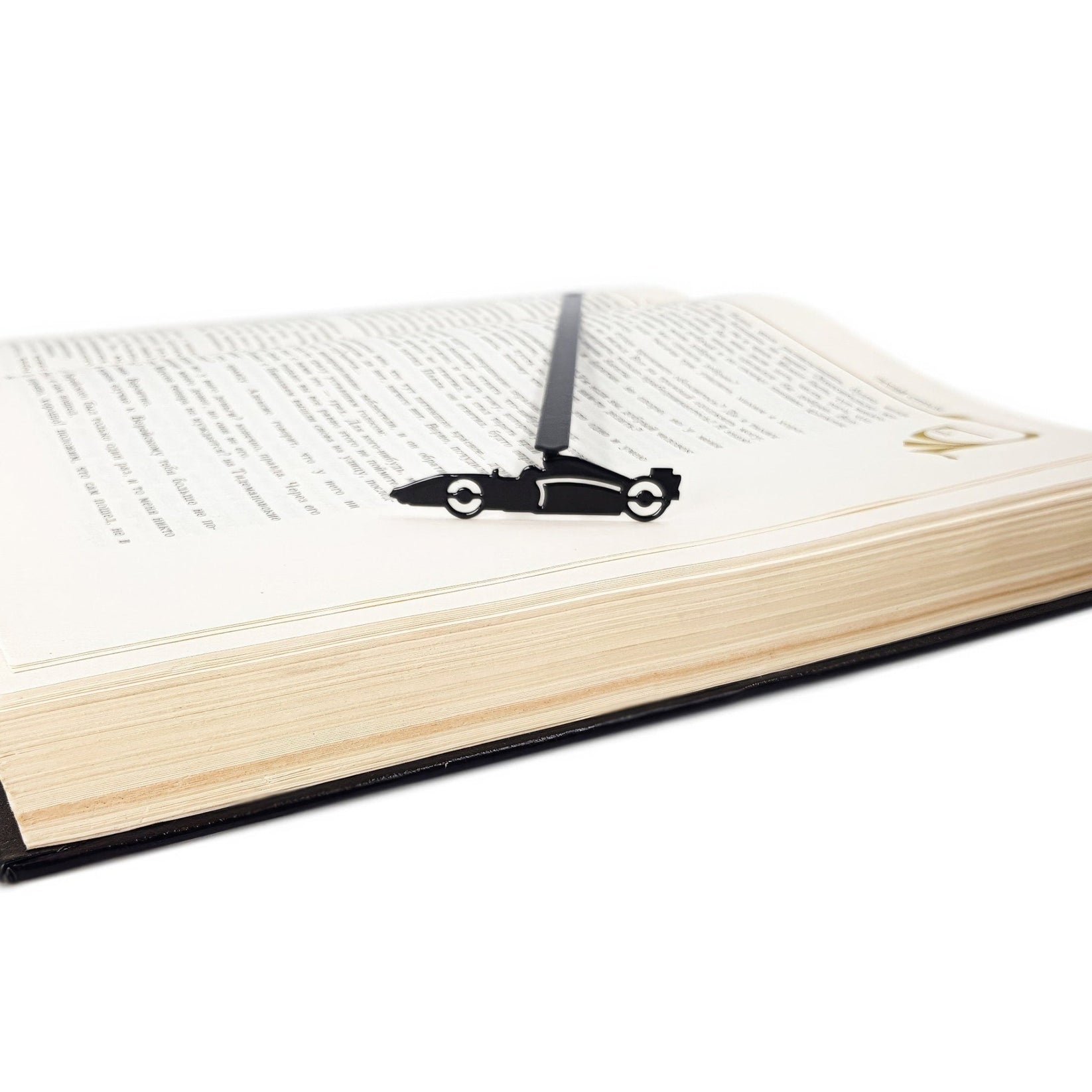 Formula One Indy Car metal bookmark seen from the edge of a closed book