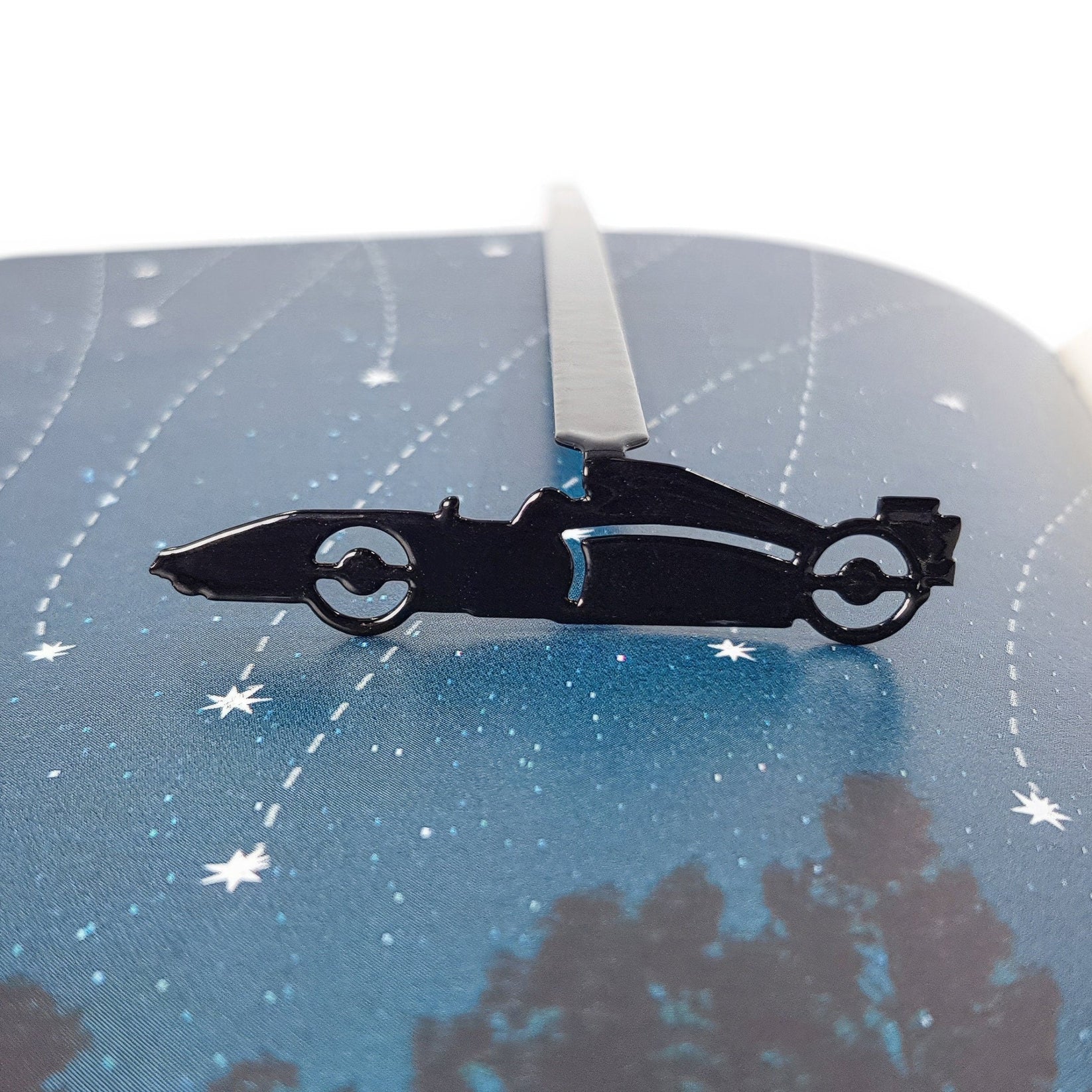 Formula One Indy Car metal bookmark on an illustrated page