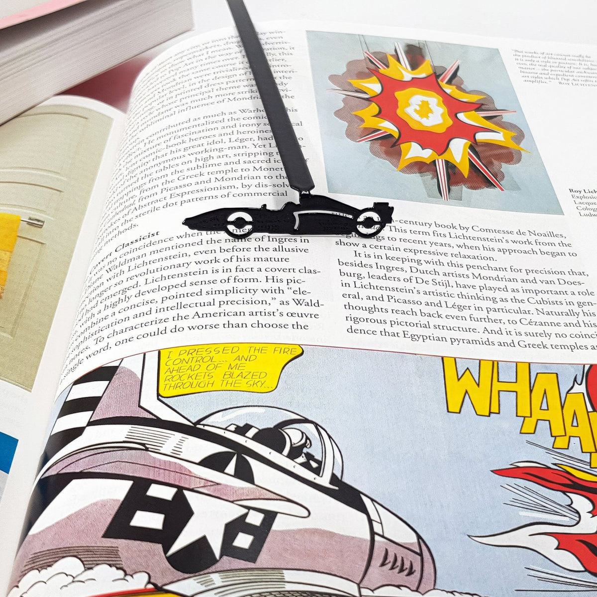 Formula One Indy Car metal bookmark marking a page in an illustrated book