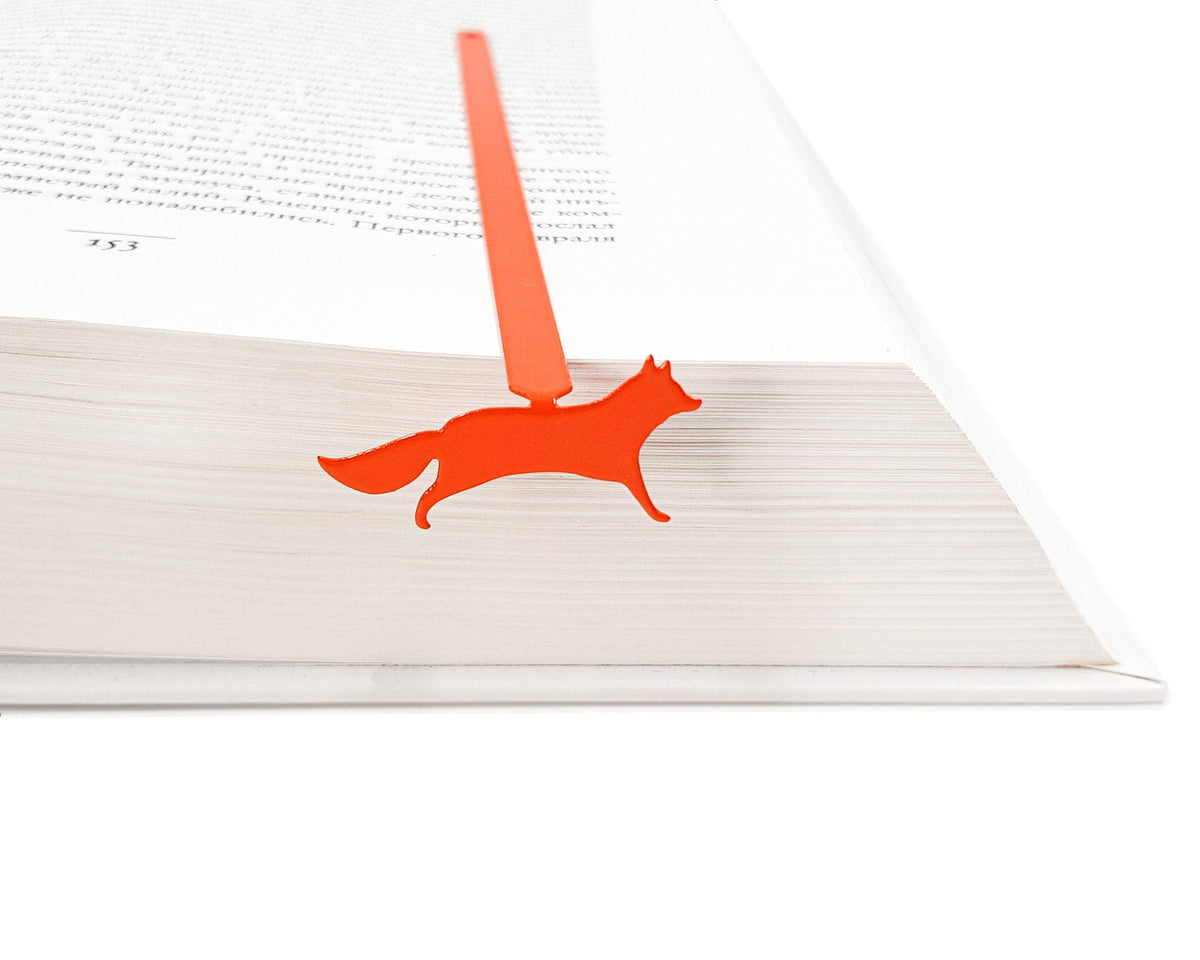Fox on the Run metal bookmark in red resting on the pages of an open book, view 5