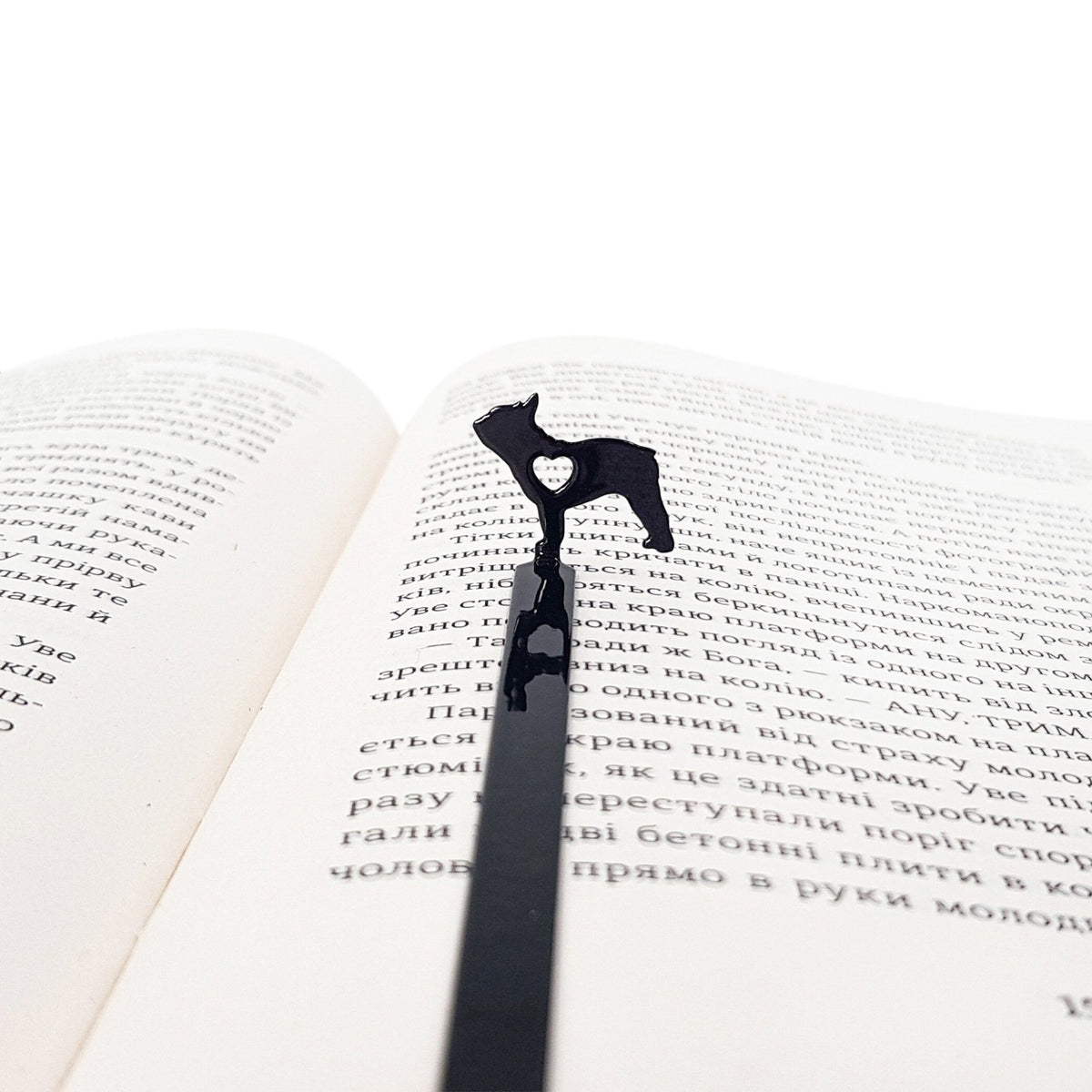 French Bulldog Love metal bookmark resting on the pages of an open book