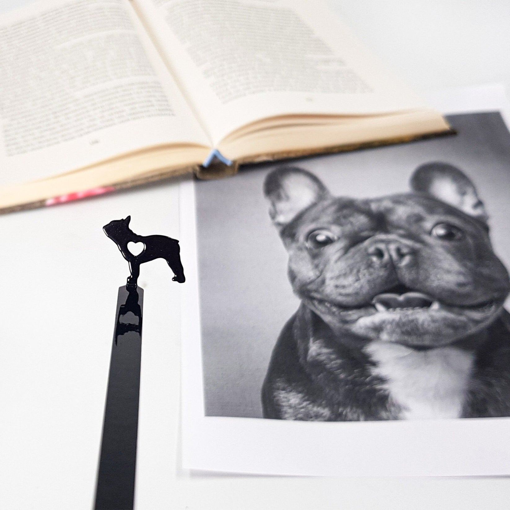 French Bulldog Love metal bookmark marking a page in an illustrated book