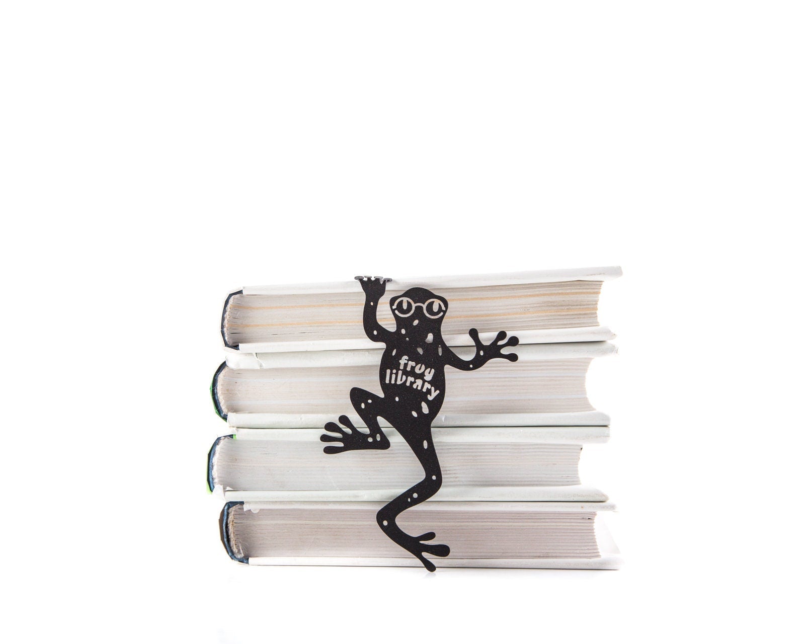 Frog Library metal bookmark shown with a stack of books