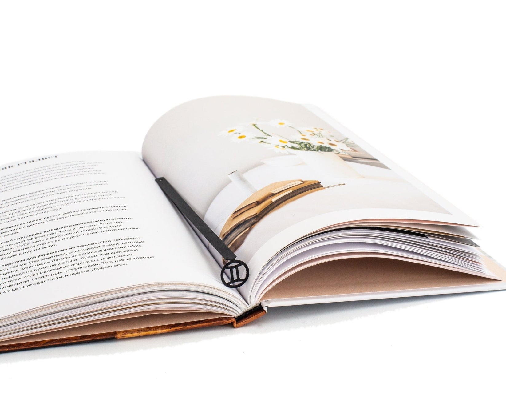Gemini metal bookmark resting on the pages of an open book