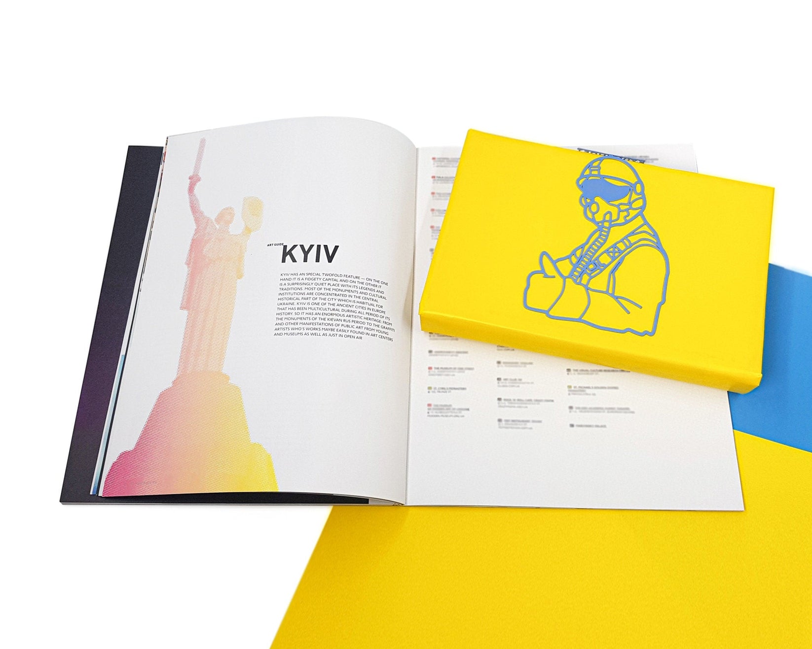 Ghost of Kyiv metal bookmark in blue lying across the pages of an open book