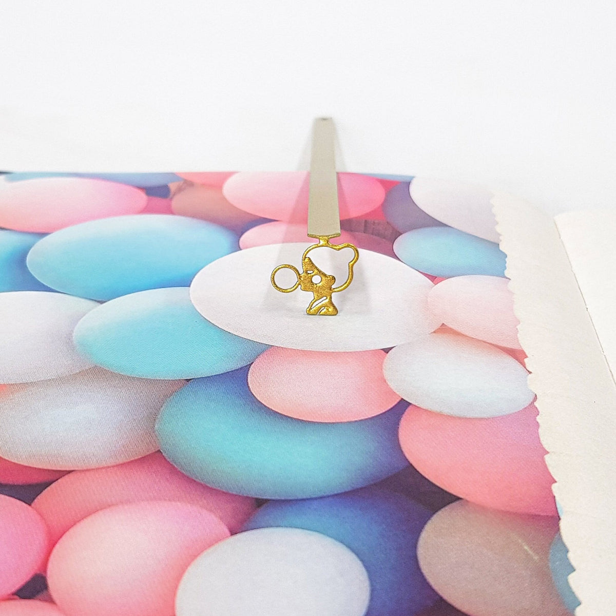 Girl with a Bubble Gum metal bookmark in gold against a coloured backdrop