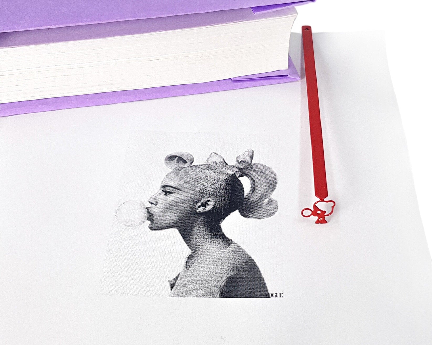 Girl with a Bubble Gum metal bookmark marking a page in an illustrated book
