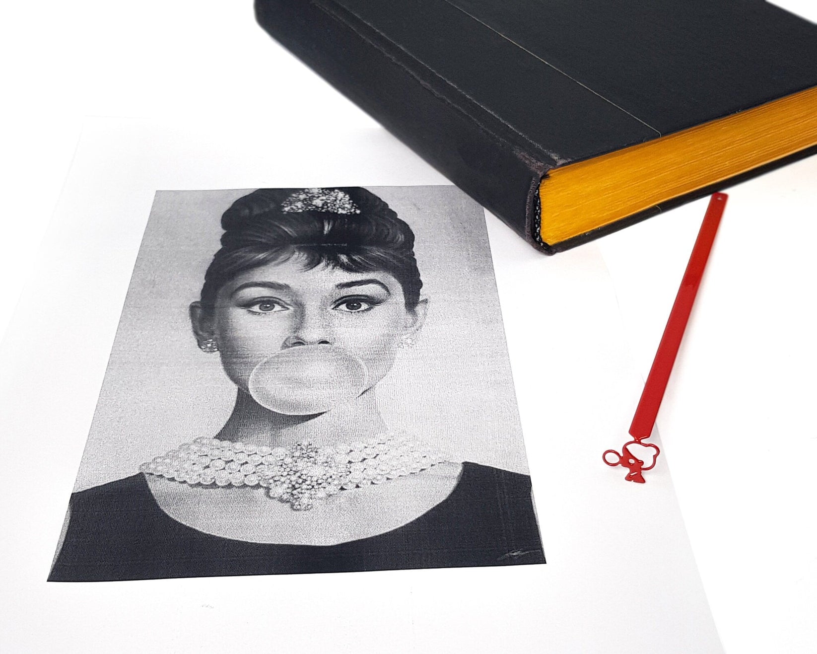 Girl with a Bubble Gum metal bookmark placed on a colour illustration