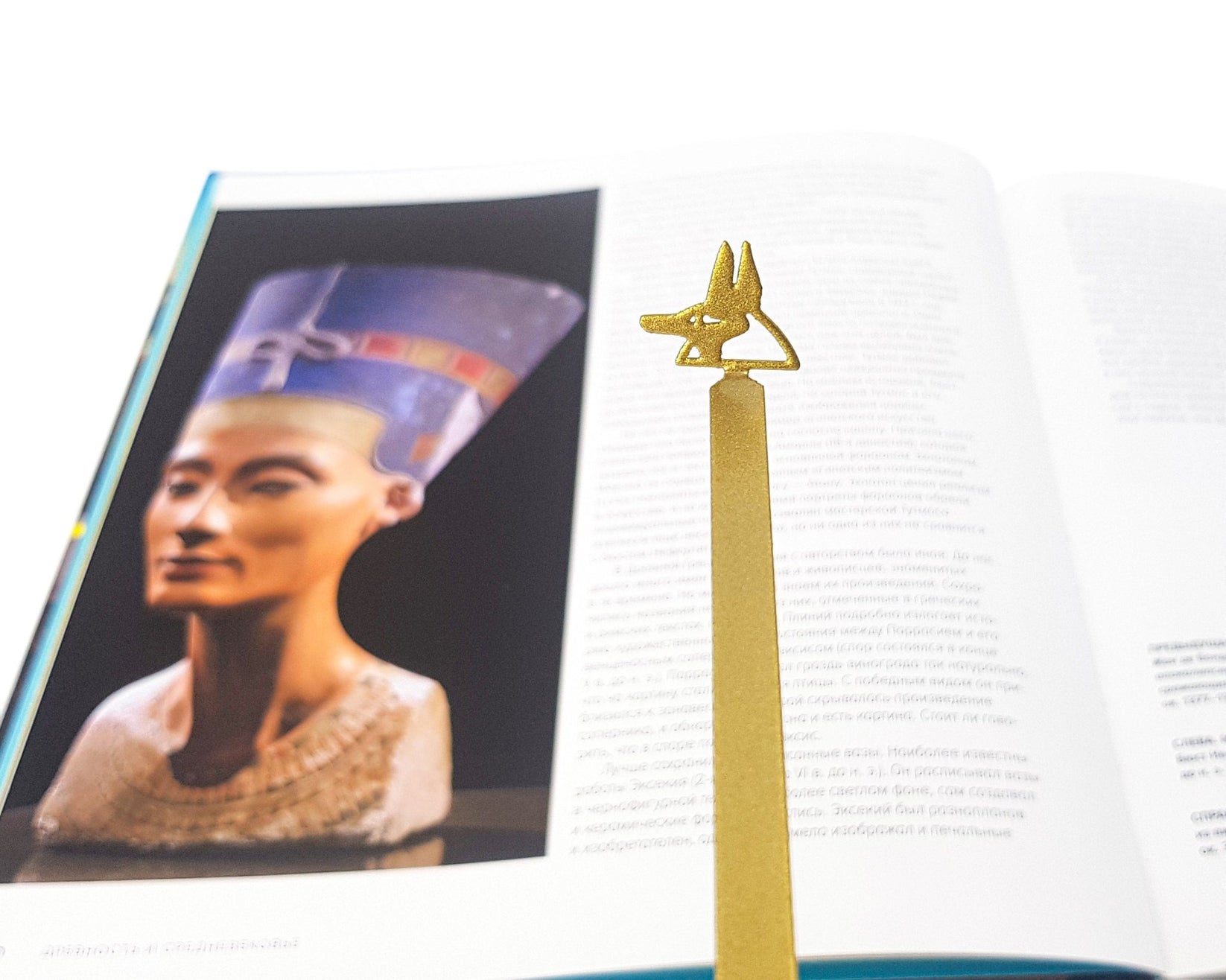 God of Death Anubis metal bookmark marking a page in an illustrated book