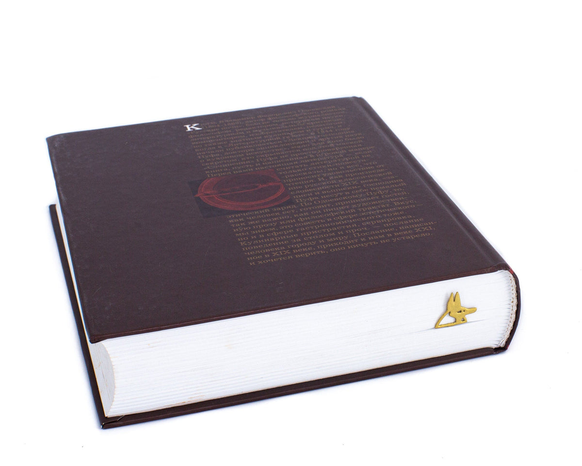 God of Death Anubis metal bookmark in gold marking a place in a closed book