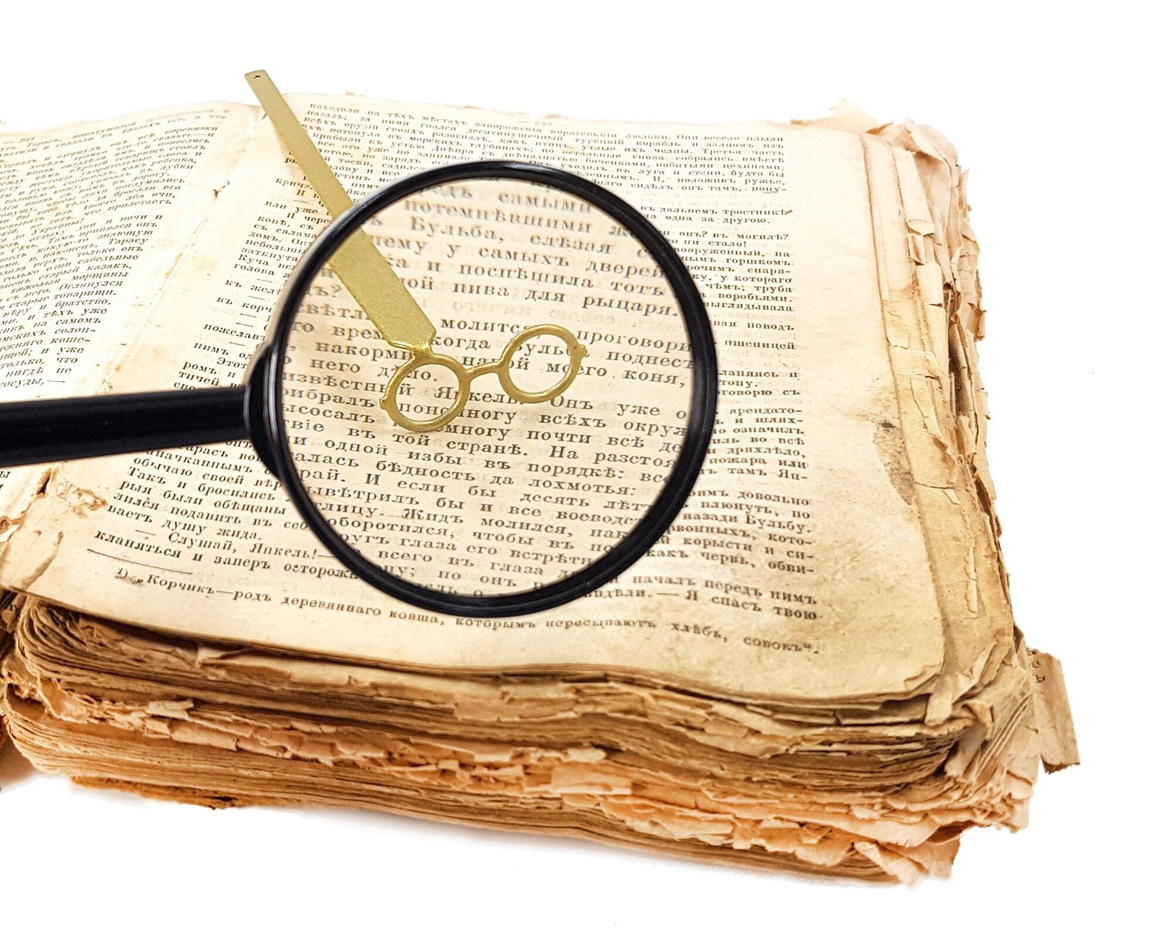 Golden Round Glasses metal bookmark in gold set into the gutter of an open book