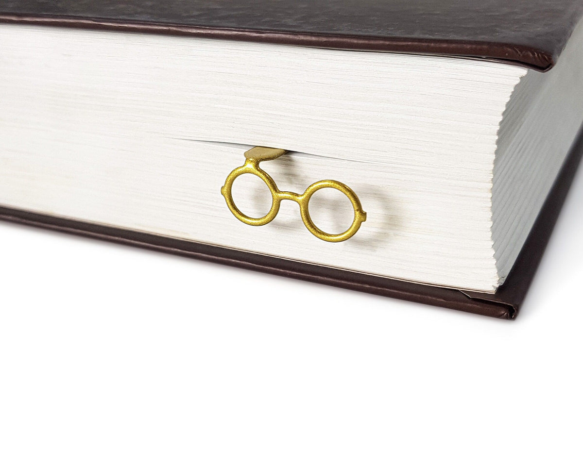 Golden Round Glasses metal bookmark in gold in a closed book, only its top showing above the pages
