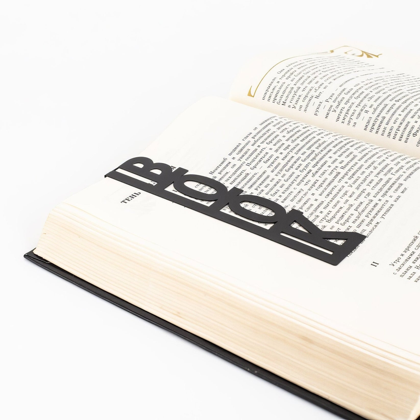 Good Book metal bookmark marking a page in an open book