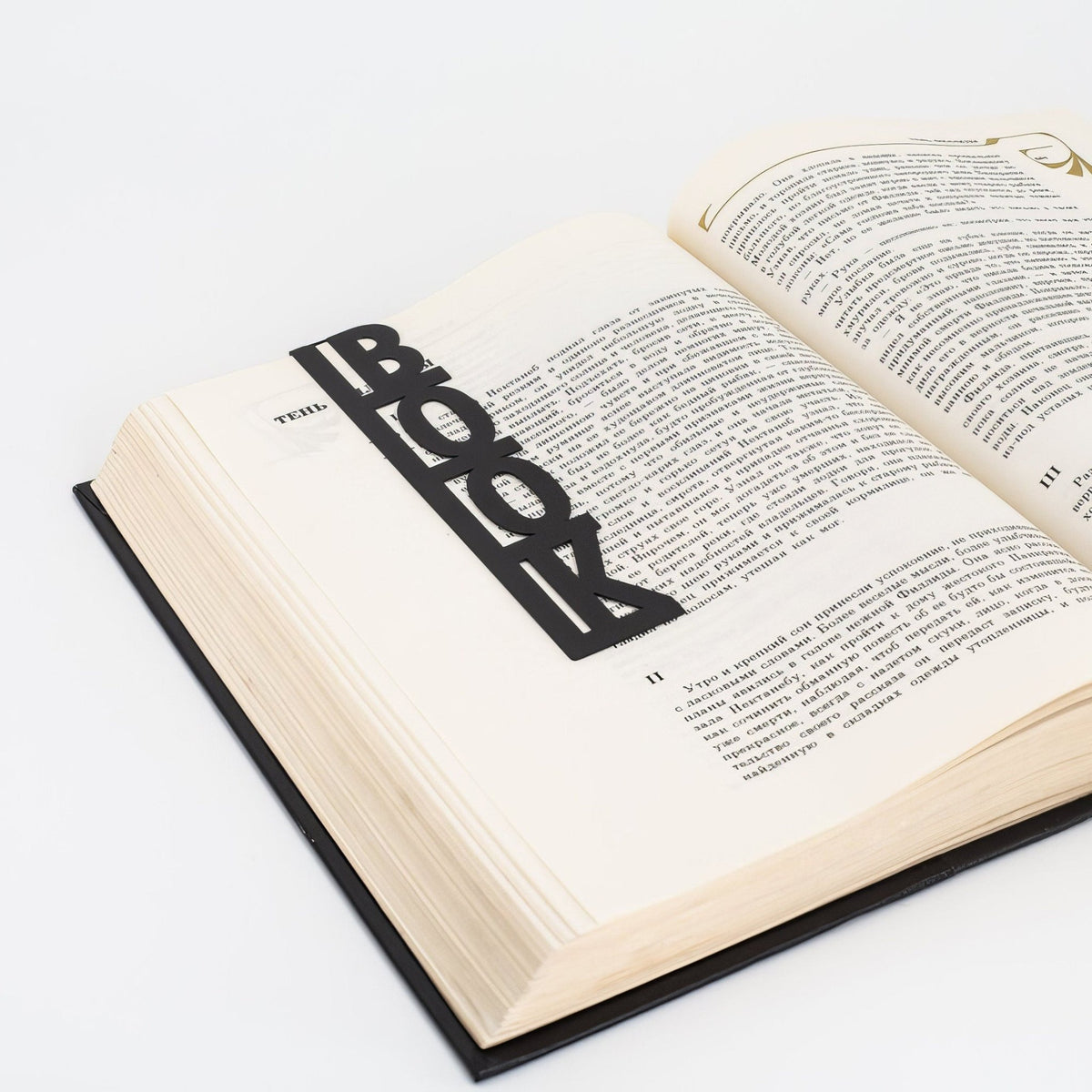 Good Book metal bookmark resting on the pages of an open book