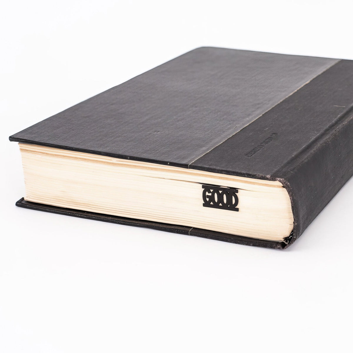 Good Book metal bookmark seen from the edge of a closed book