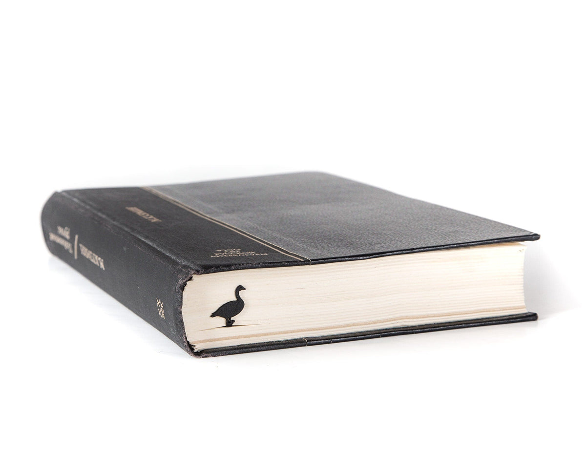 Goose metal bookmark in a closed book, only its top showing above the pages