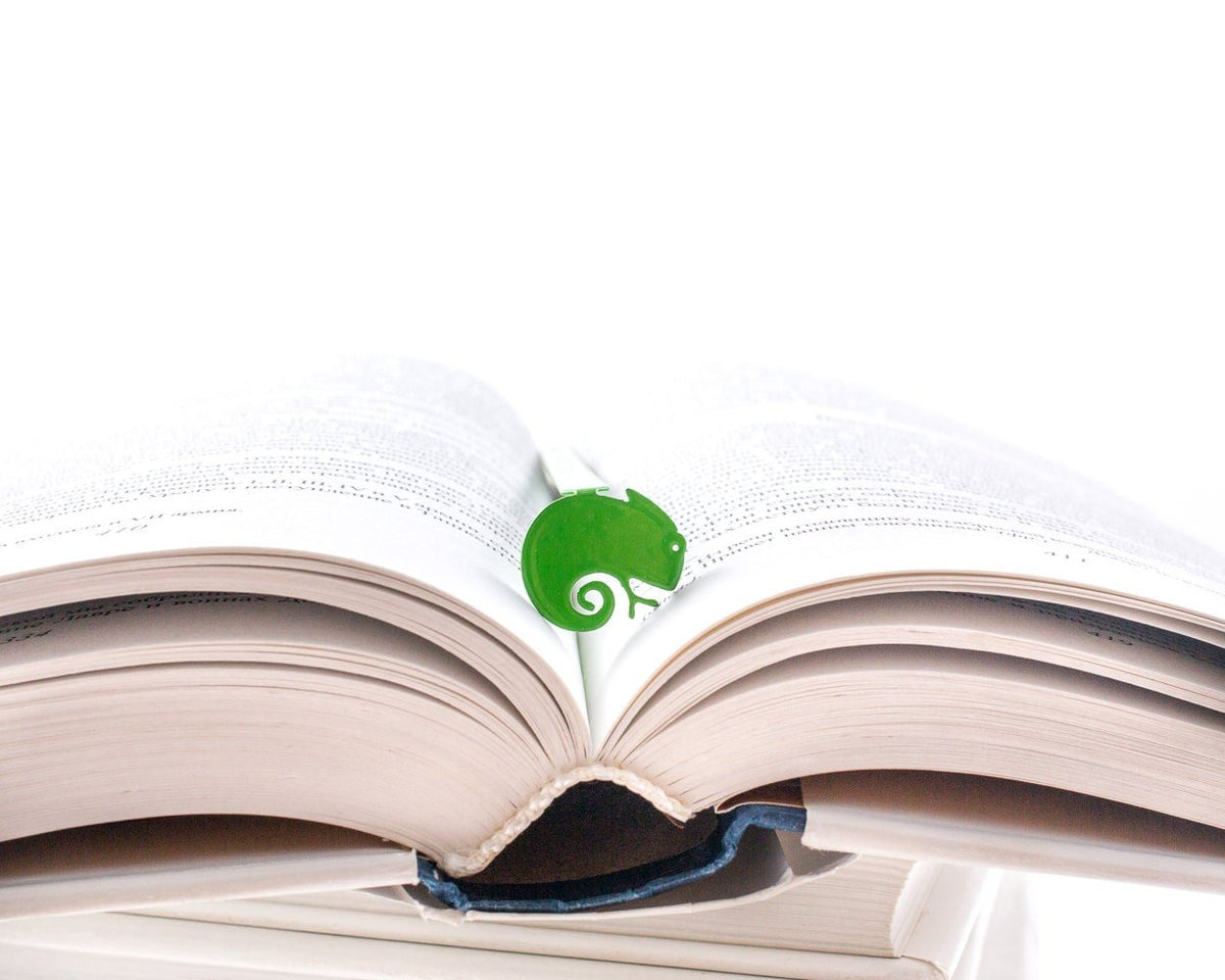 Green Lizard metal bookmark in green resting on the pages of an open book