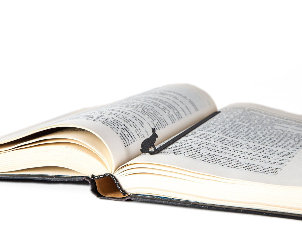 Hare metal bookmark resting on the pages of an open book