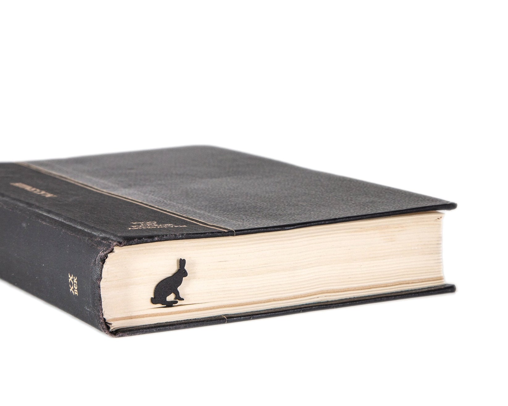 Hare metal bookmark in a closed book, only its top showing above the pages