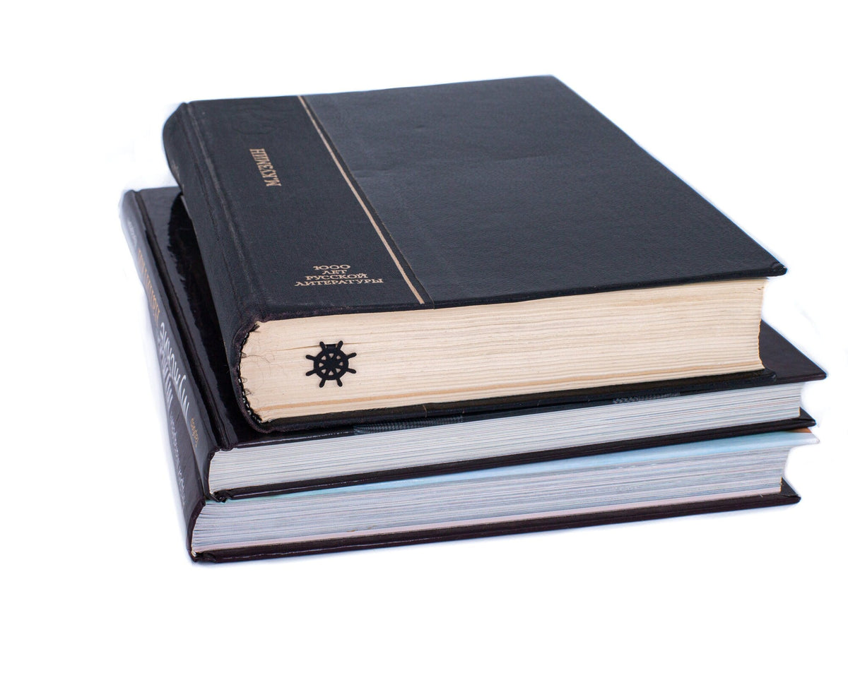 Helm metal bookmark shown with a stack of books