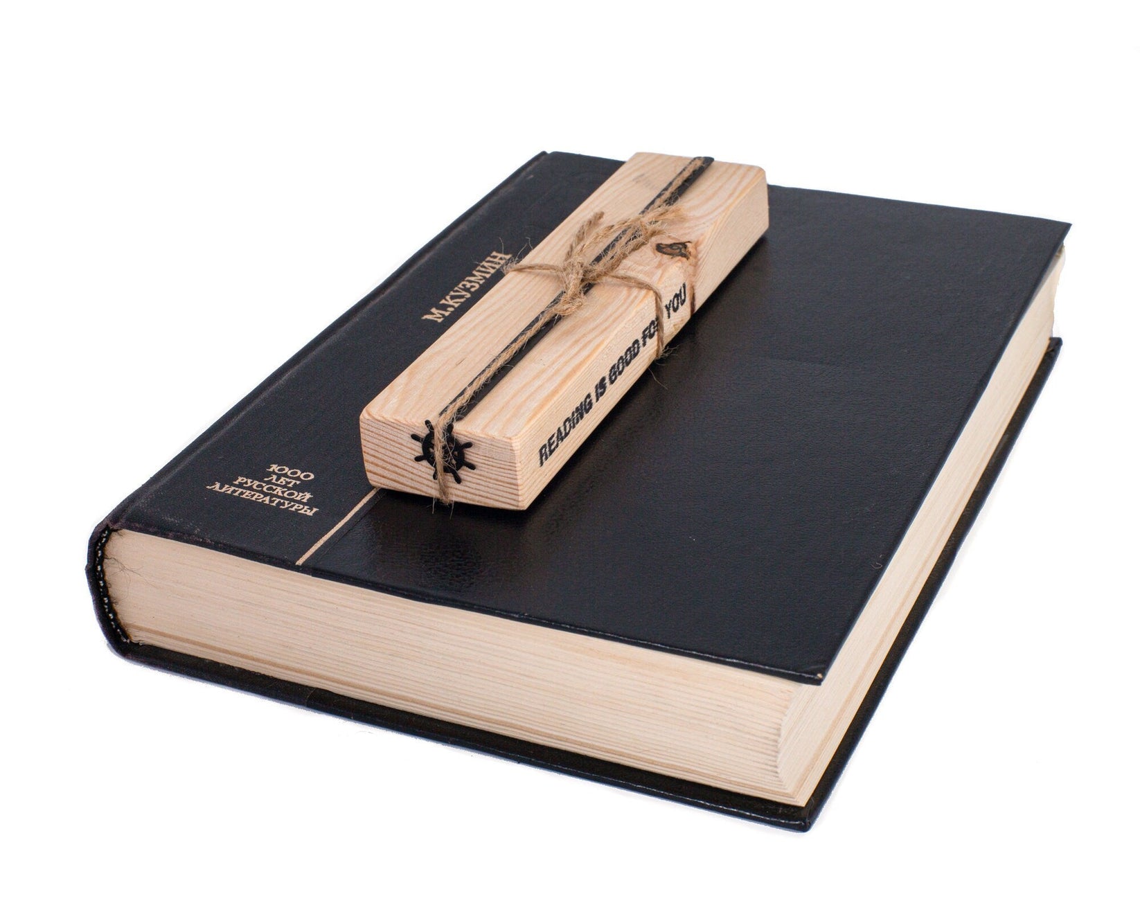 Helm metal bookmark in a closed book, only its top showing above the pages