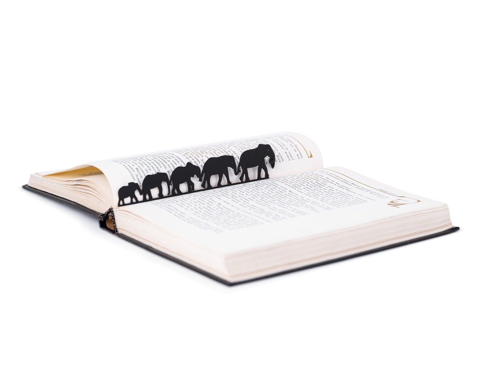Herd of Elephants metal bookmark lying across the pages of an open book