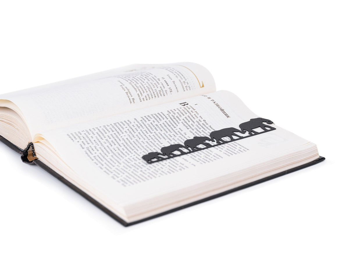Herd of Elephants metal bookmark marking a page in an open book