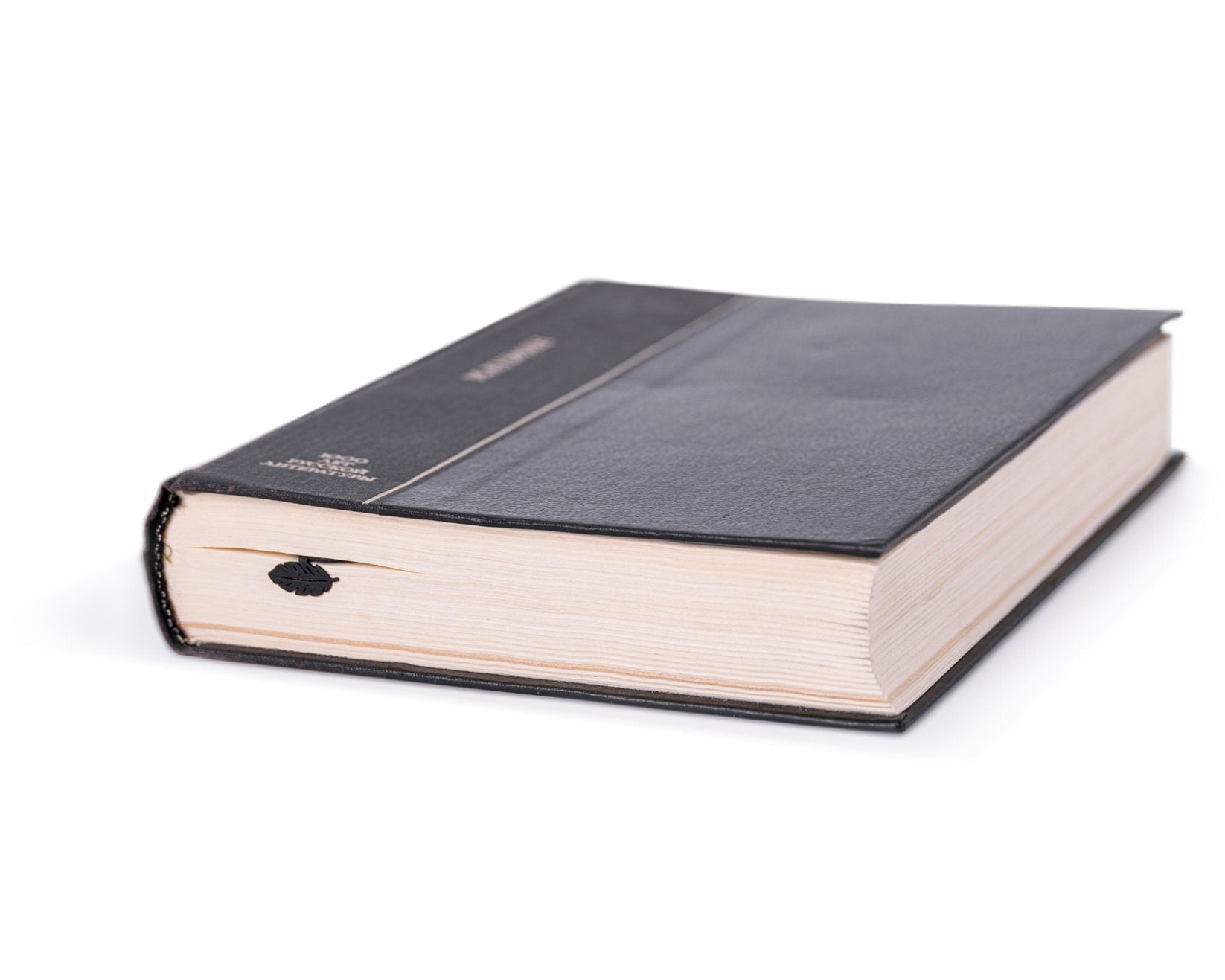 Herd of Elephants metal bookmark in a closed book, only its top showing above the pages