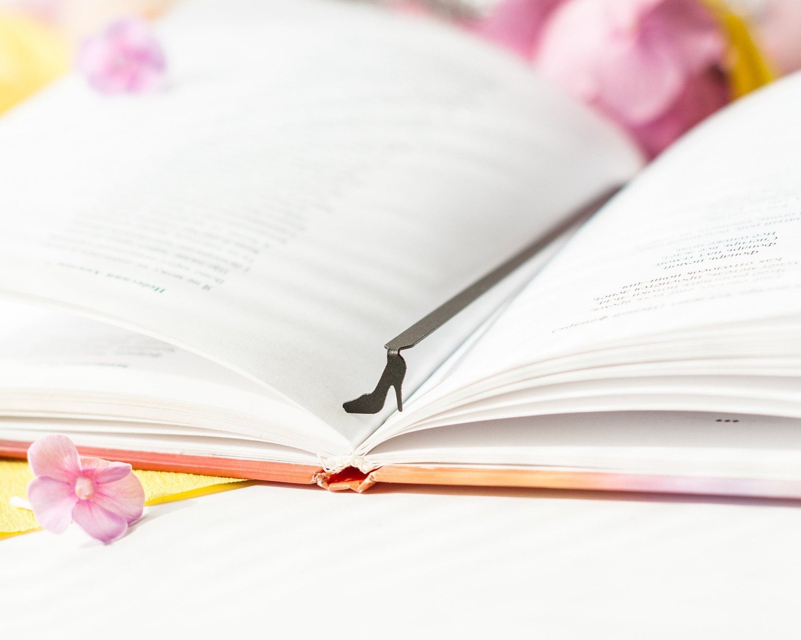 High Heel Shoe metal bookmark resting on the pages of an open book
