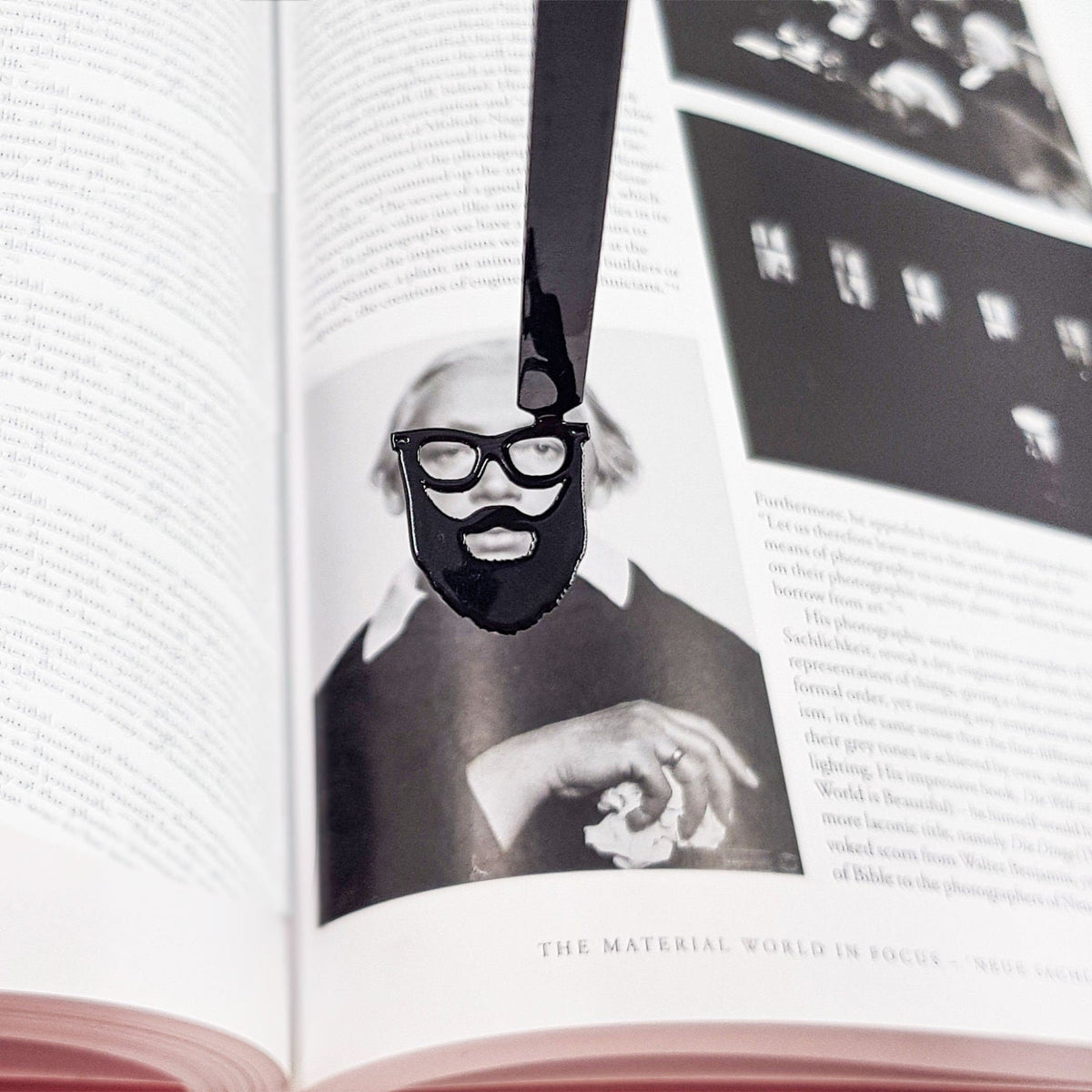 Hipster metal bookmark placed on a colour illustration