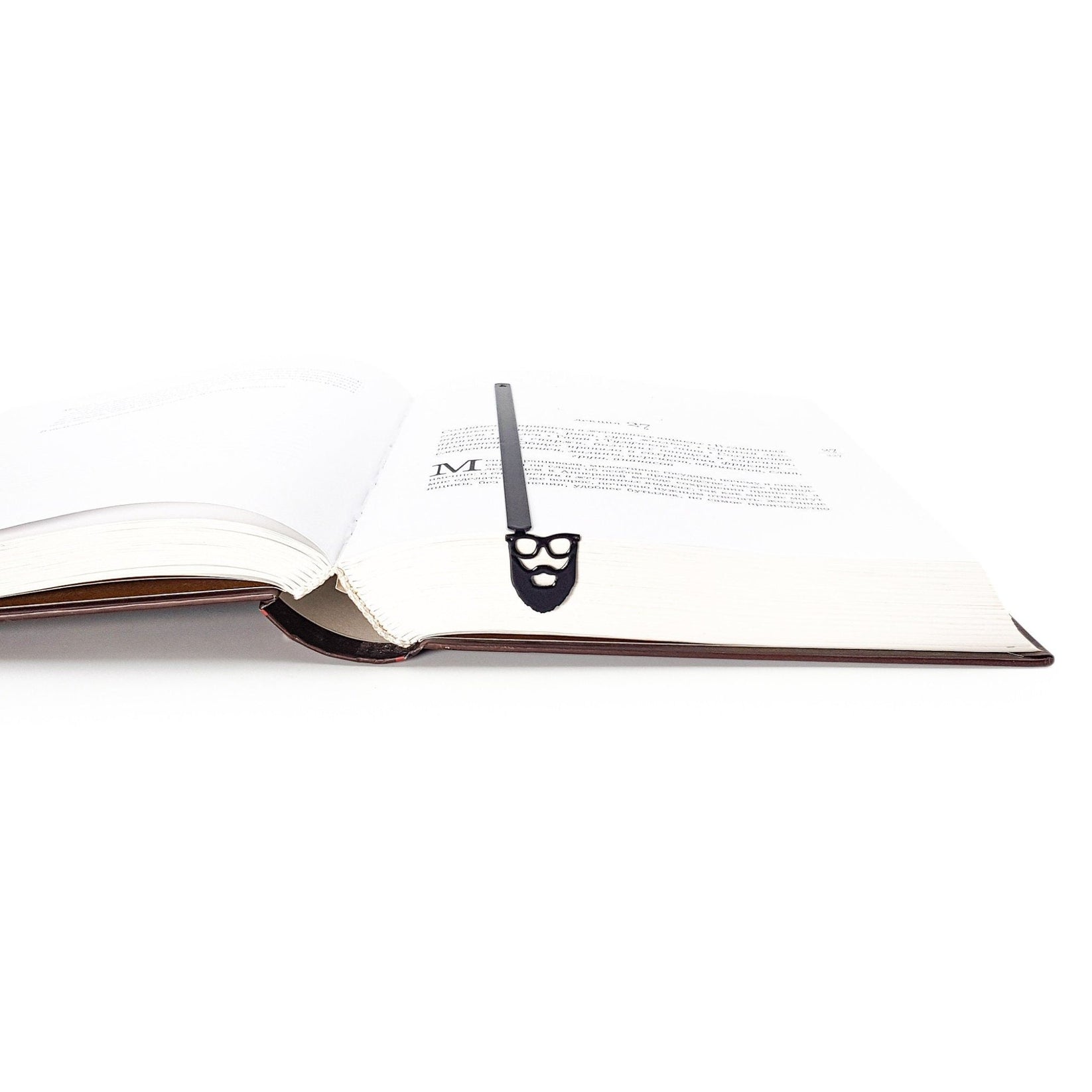 Hipster metal bookmark resting on the pages of an open book