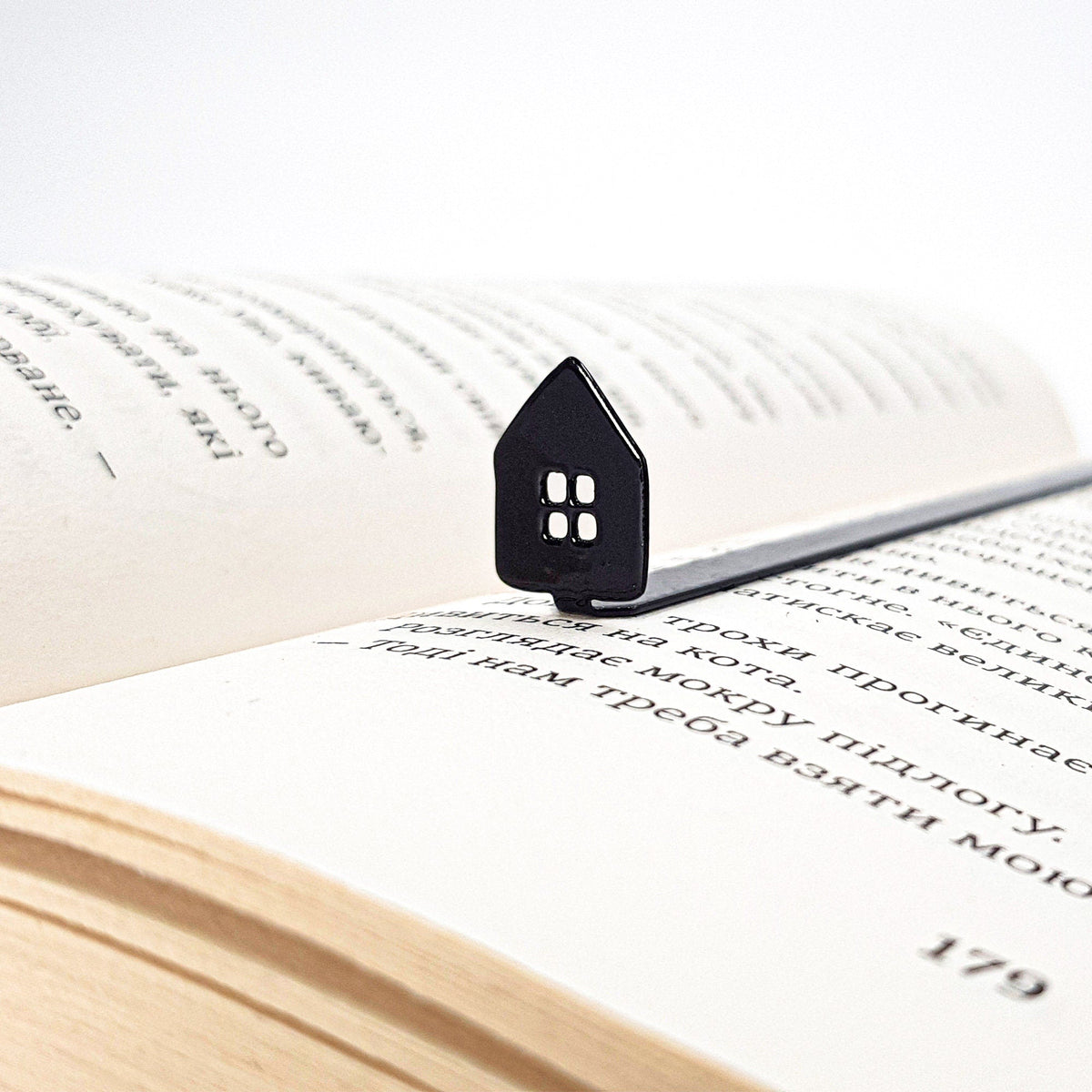 Home Sweet Home metal bookmark resting on the pages of an open book