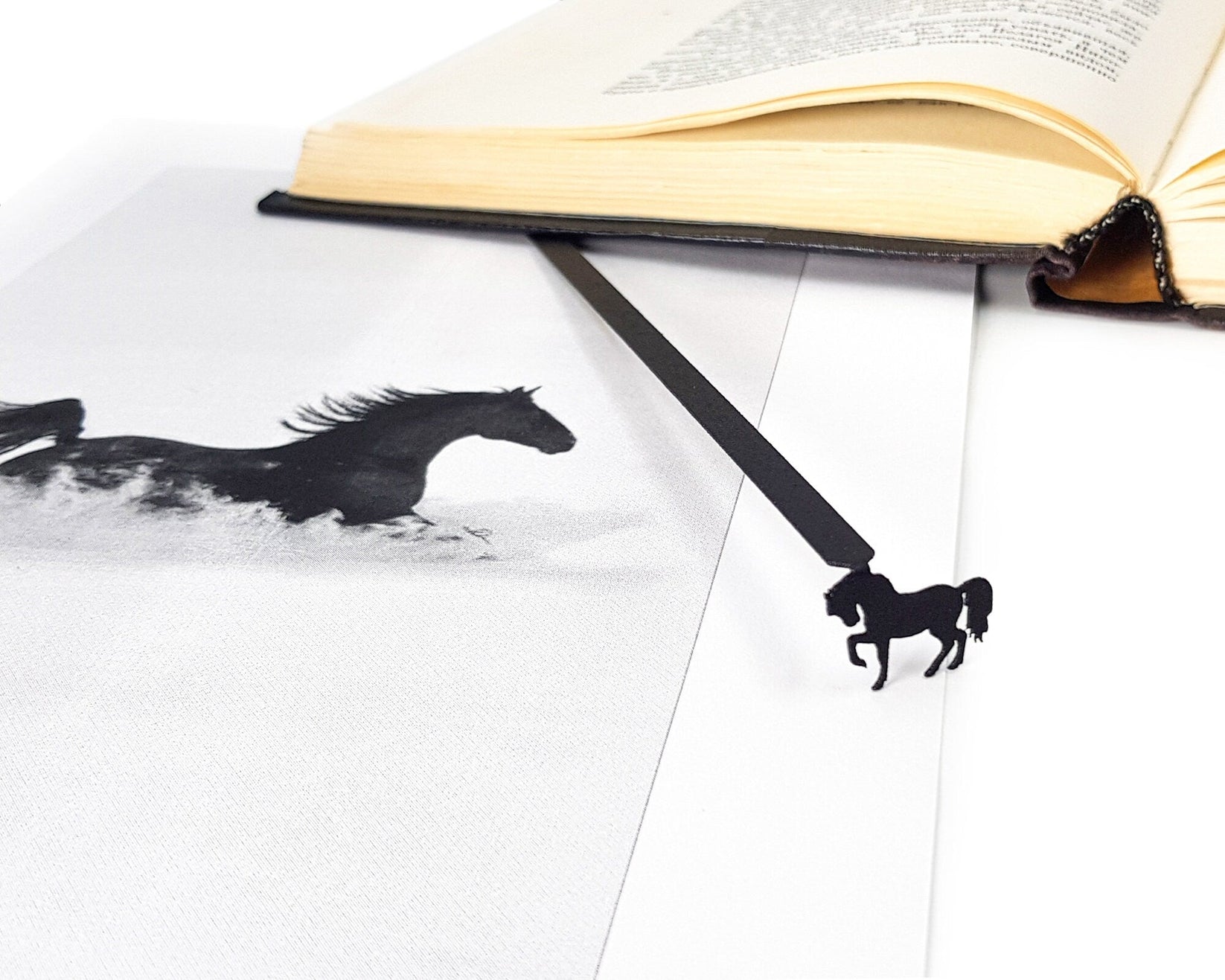 Horse metal bookmark on an illustrated page