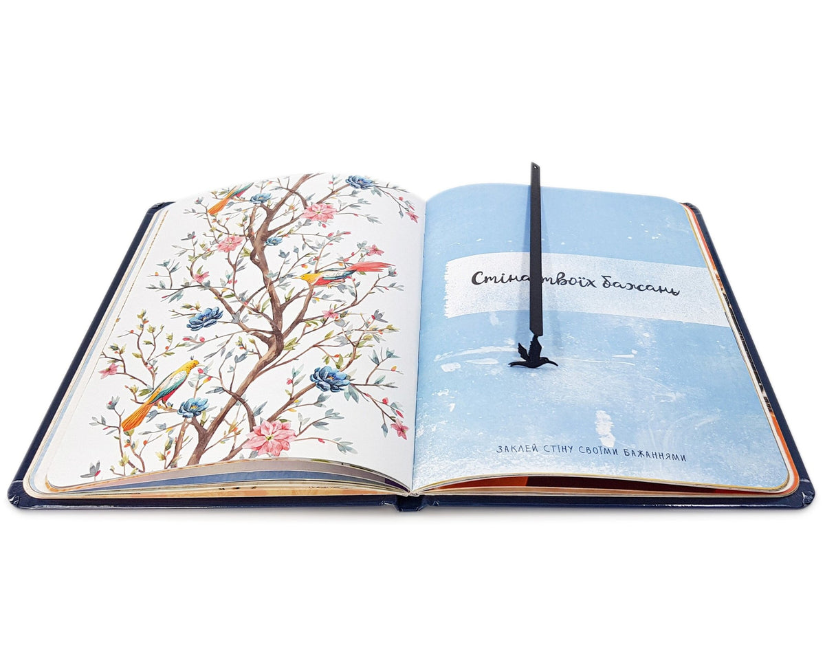 Hummingbird metal bookmark on an illustrated page