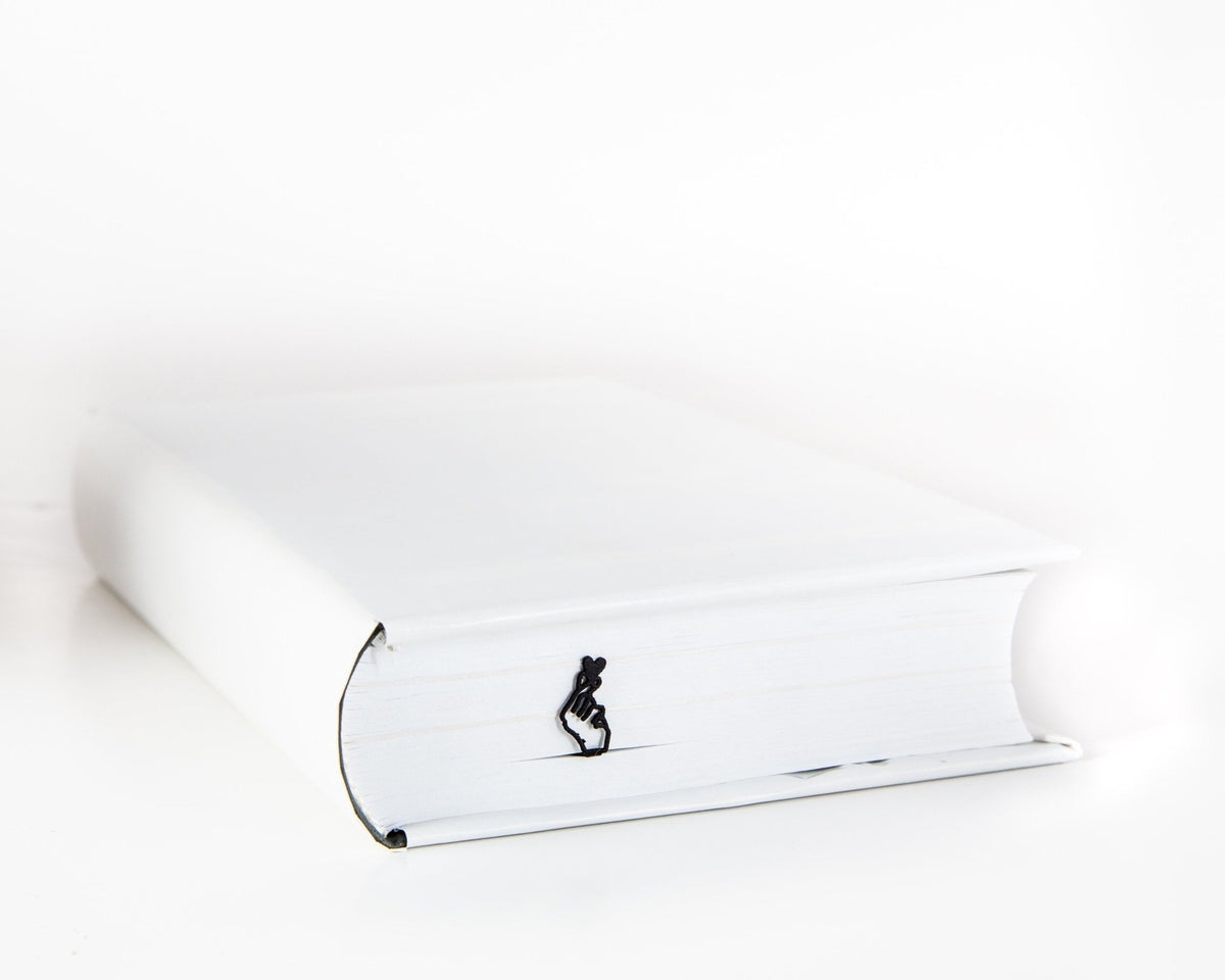 I Am Giving You My Heart metal bookmark in a closed book, only its top showing above the pages