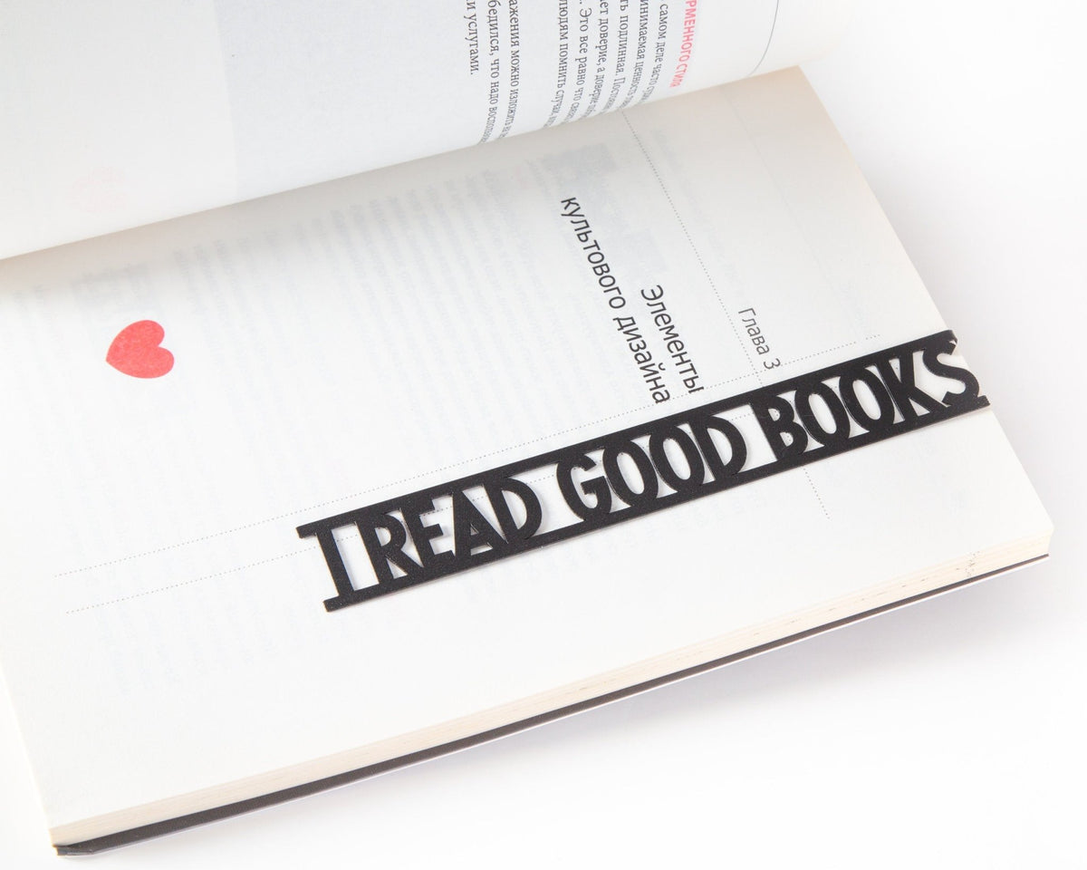 I Read Good Books metal bookmark resting on the pages of an open book