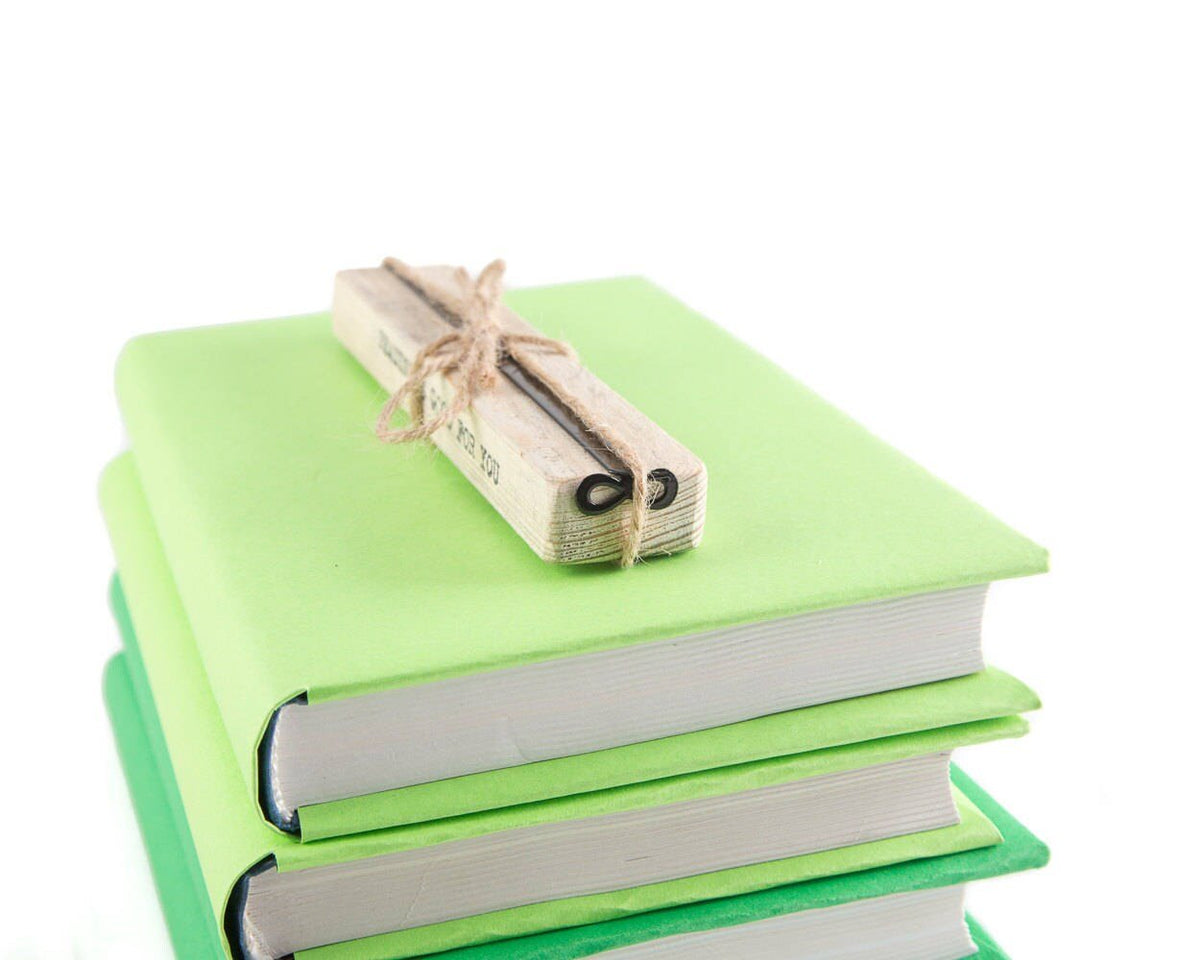 Infinity metal bookmark with the engraved wooden gift block it ships with