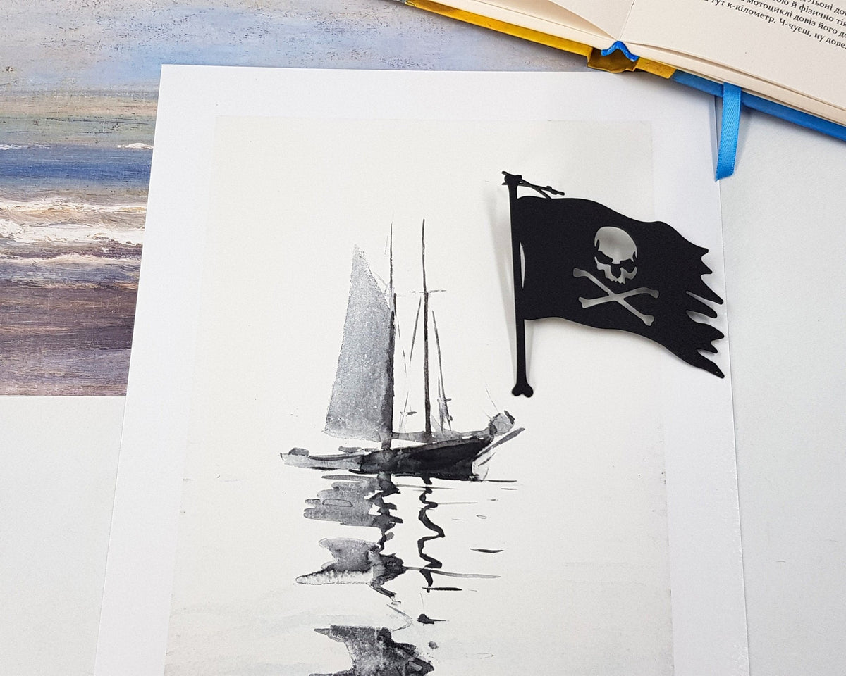 Jolly Rogers metal bookmark marking a page in an illustrated book