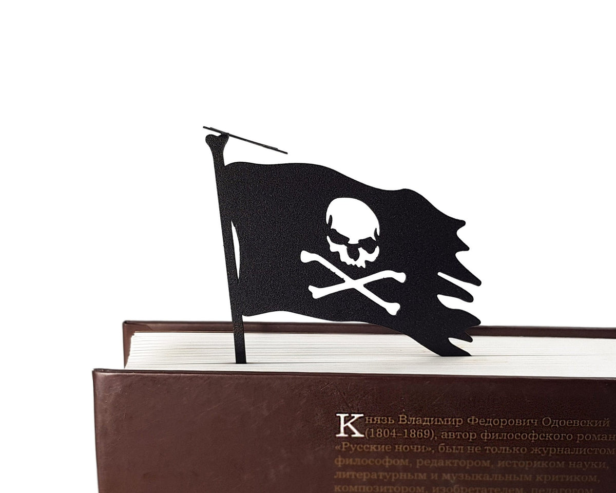 Jolly Rogers metal bookmark seen from the edge of a closed book